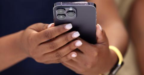 A woman holding a refurbished phone
