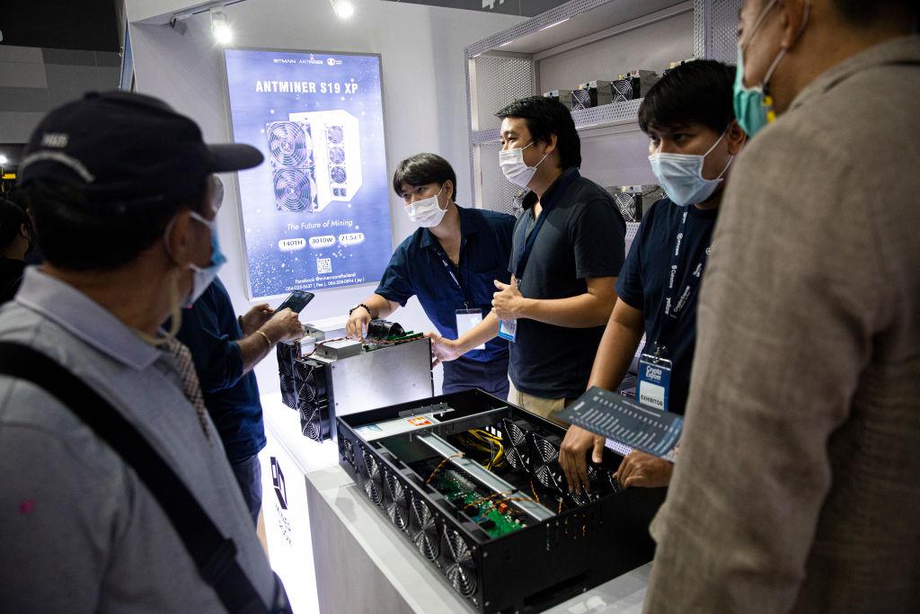 People learn about mining rigs at the Thailand Crypto Expo on May 14, 2022 in Bangkok, Thailand. Cryptocurrency Enthusiasts attend Thailand Crypto Expo 2022, the largest cryptocurrency exposition in Southeast Asia, at the Bangkok International Trade and Exhibition Center. Visitors learn about blockchain projects, exchanges, mining, NFT production, and gamefi technology. The exposition comes during a globa