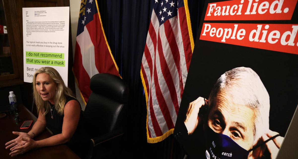  U.S. Rep. Marjorie Taylor Greene with Fauci poster in background