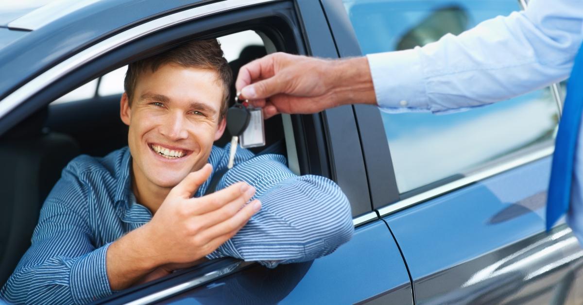 A man in car accepting the keys.