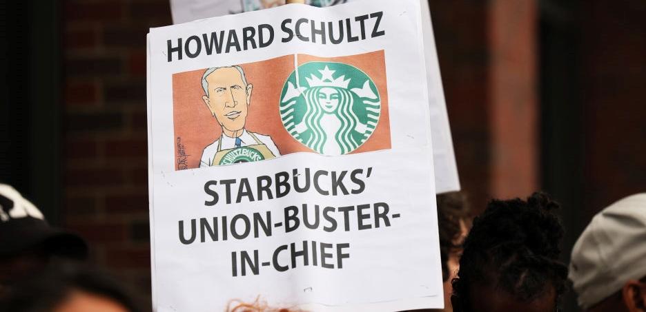 Sign reading Howard Schultz Starbucks' Union-buster-in-chief