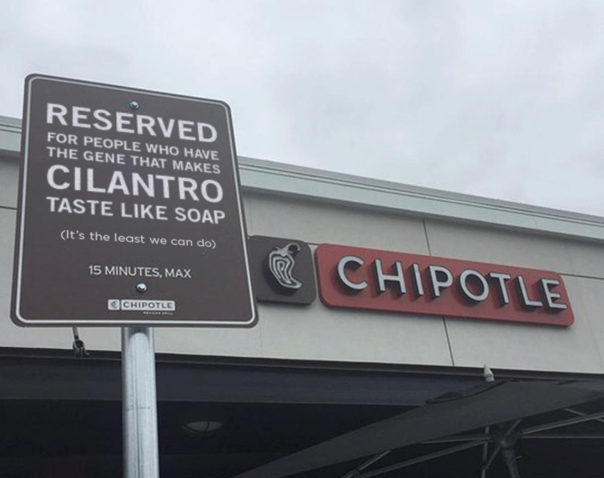 A Chipotle parking sign and restaurant sign.