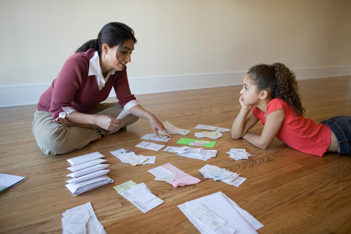 Mother going through bills with daughter 