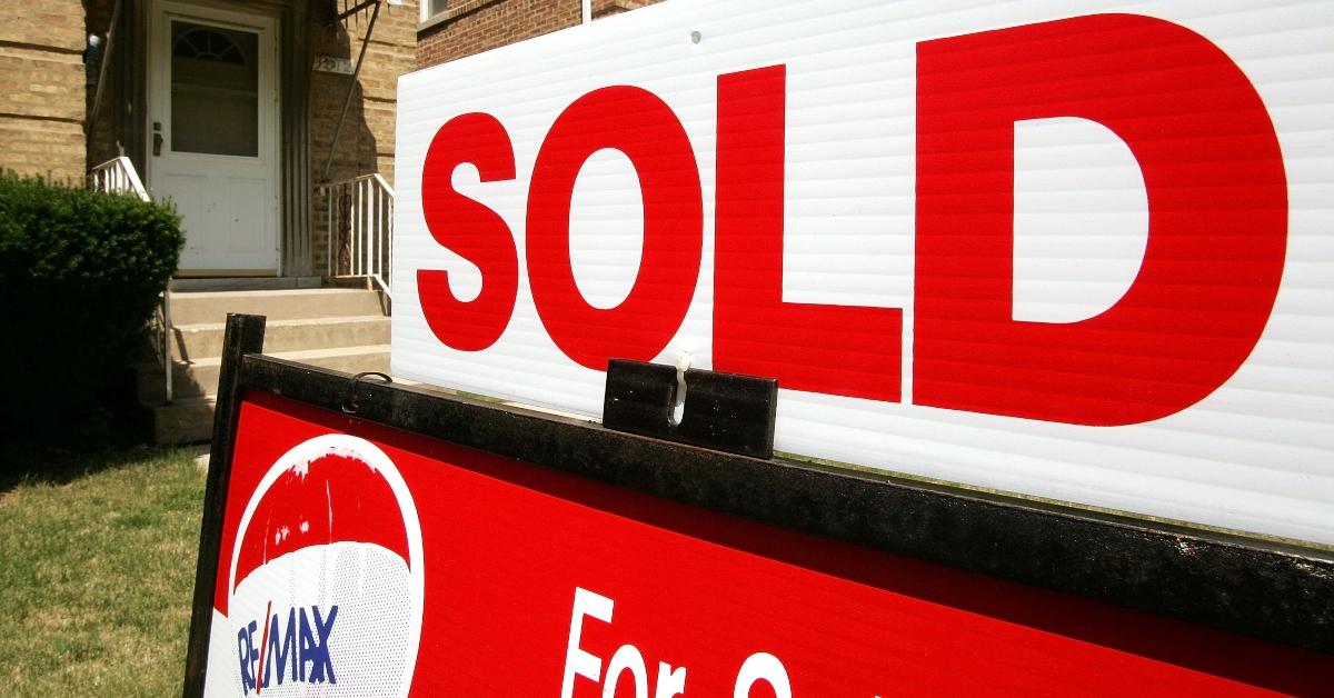 A RE/MAX sale sign on a front lawn