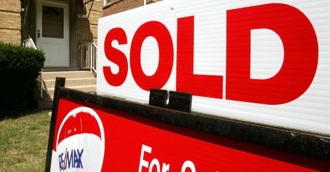 A RE/MAX sale sign on a front lawn