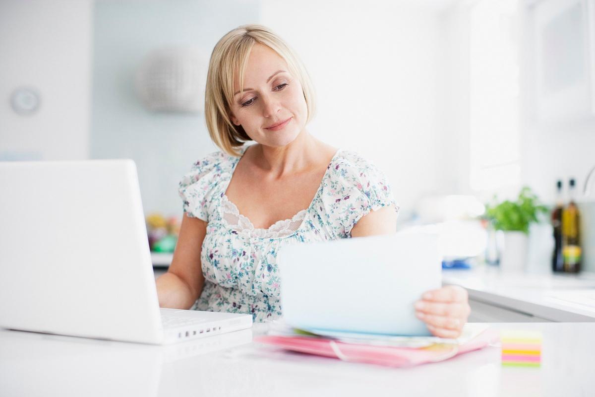 A person paying bills online with laptop