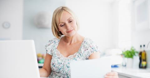A person paying bills online with laptop