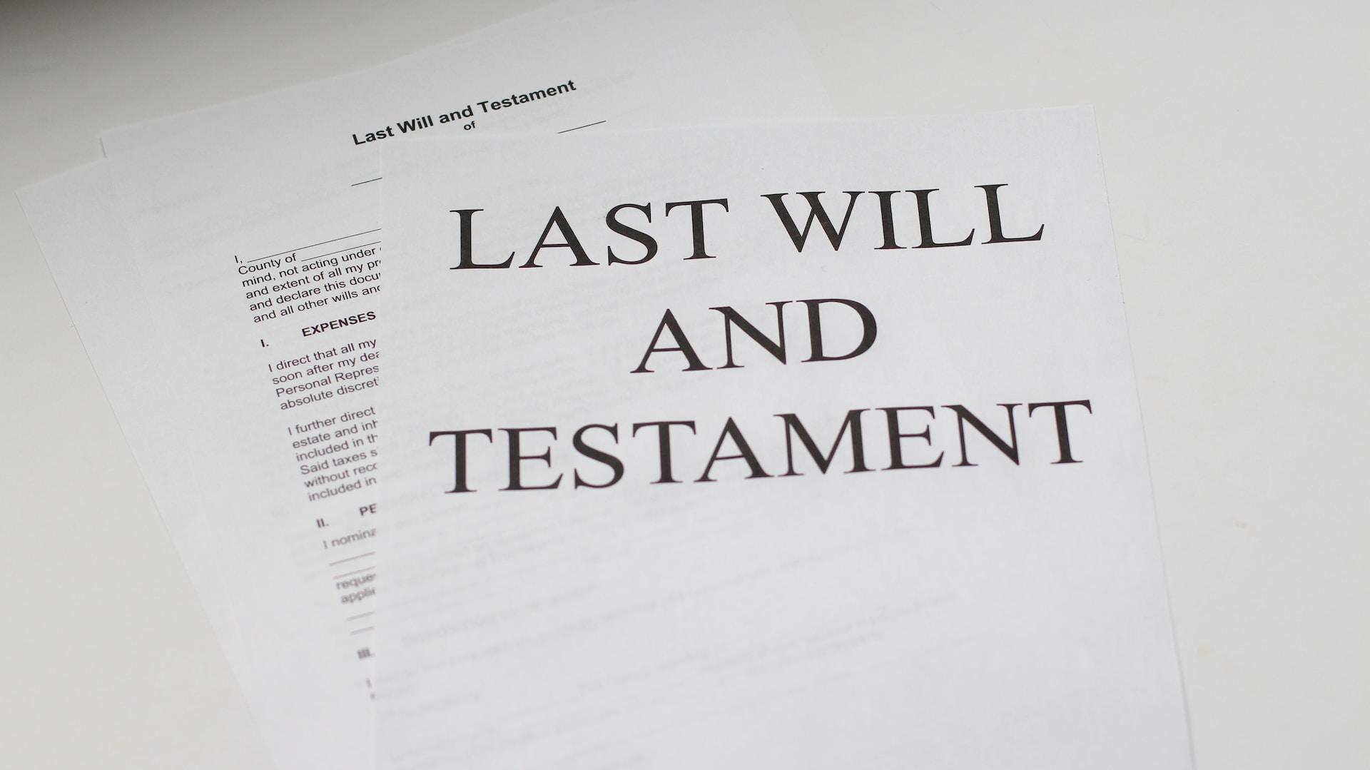 A black-and-white still image of last will and testament papers 