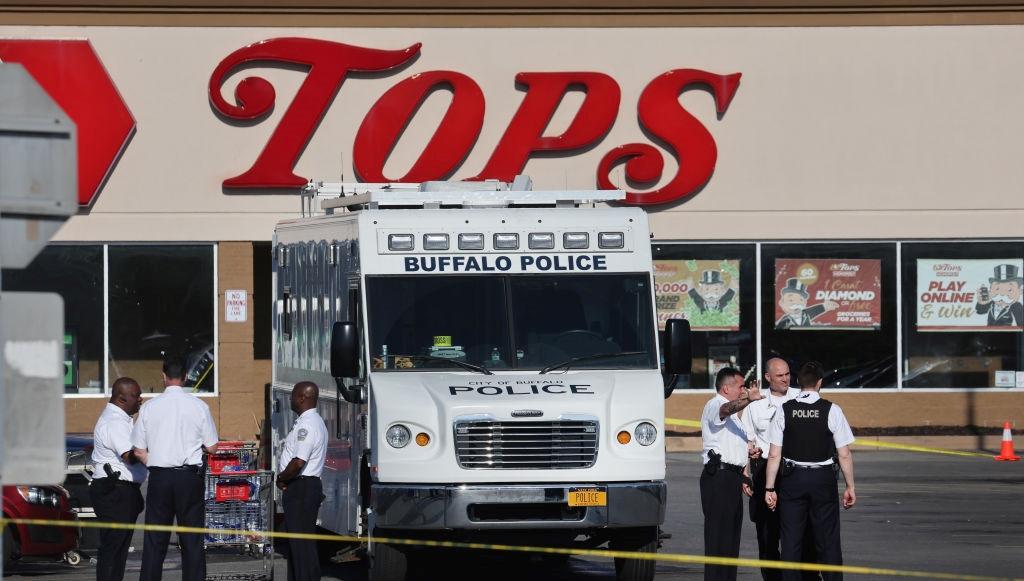 Buffalo police van outside of Tops supermarket after racist terrorist mass shooting