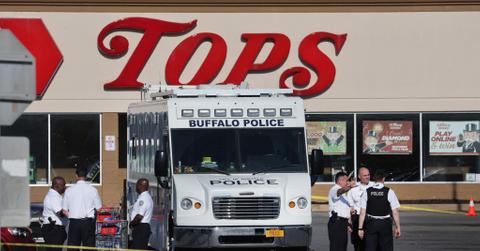 Buffalo police van outside of Tops supermarket after racist terrorist mass shooting