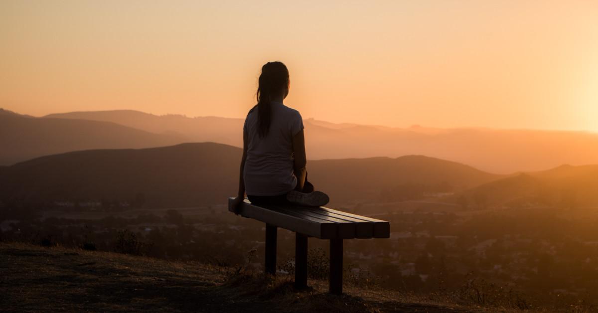 woman relaxing on bench