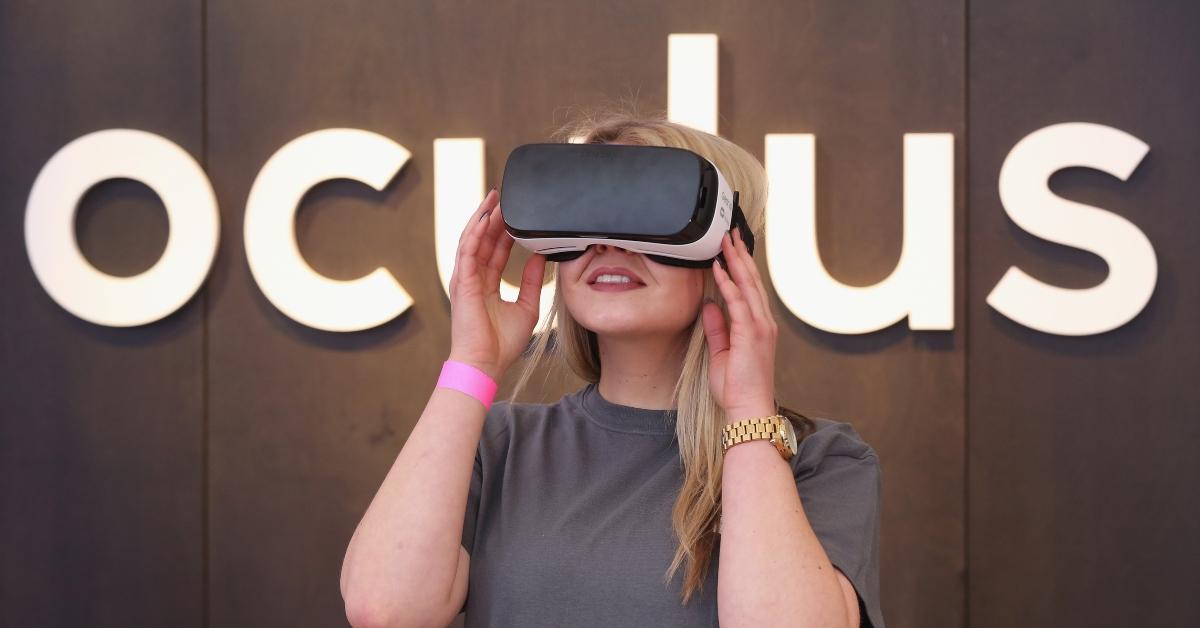 A woman looking into an Oculus device.