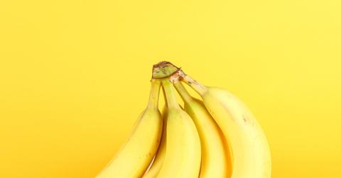 A bunch of bananas with a yellow background