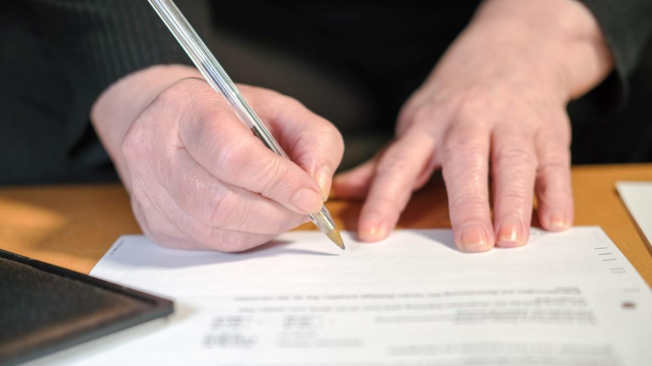 A medical transcriptionist filling out documents