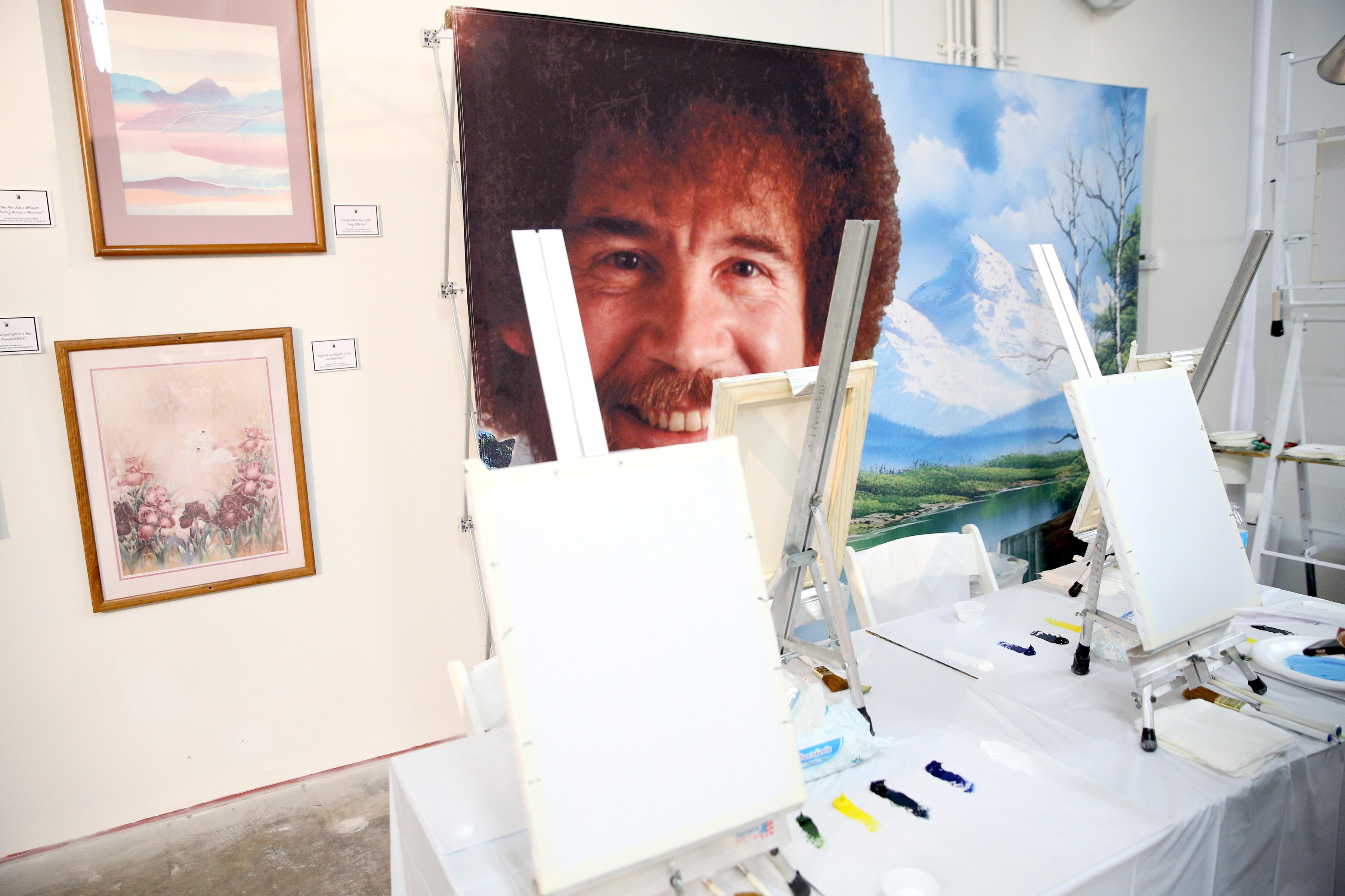 Bob Ross's image behind painting easels