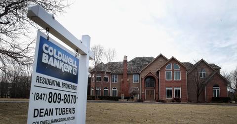 Home for sale with a sign in the front yard