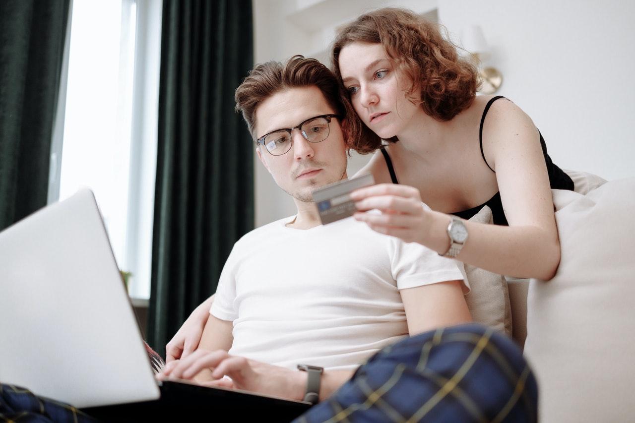 A man and a woman making online payment through a card