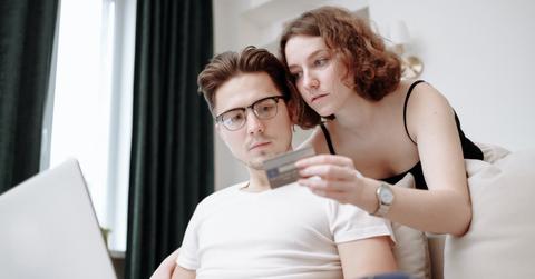 A man and a woman making online payment through a card