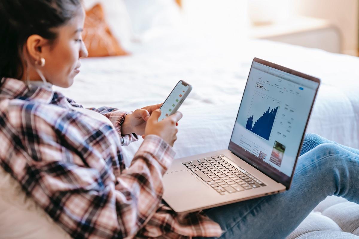 Woman using a smartphone and laptop