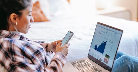 Woman using a smartphone and laptop