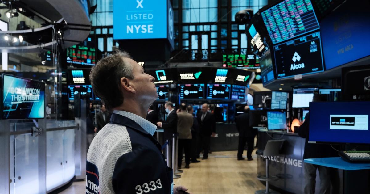 A person watching stock prices at the NYSE