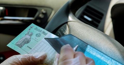 A person writing on a blank check