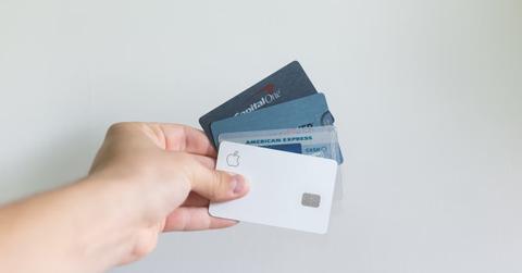 A person holding credit cards