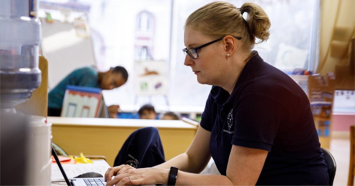 A teachers works at her desk.