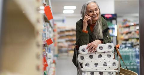 A woman shopping for toilet paper