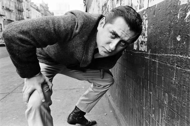 Portrait of American film director and actor Robert Downey Sr (1936 - 2021) as he crouches, hands on his knees, on an unspecified street, New York, New York, 1967. 