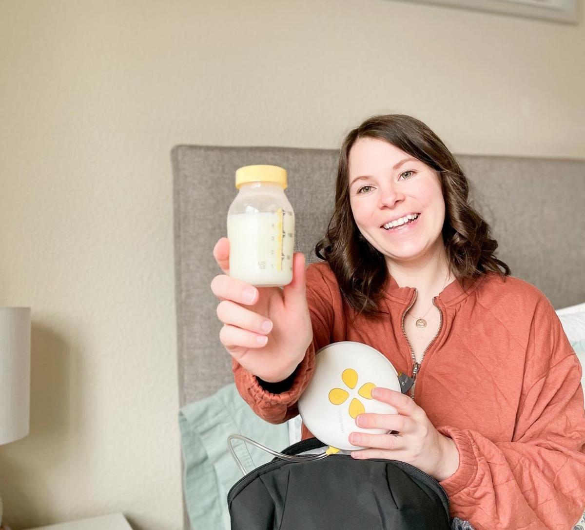 A woman holding a bottle of breast milk.