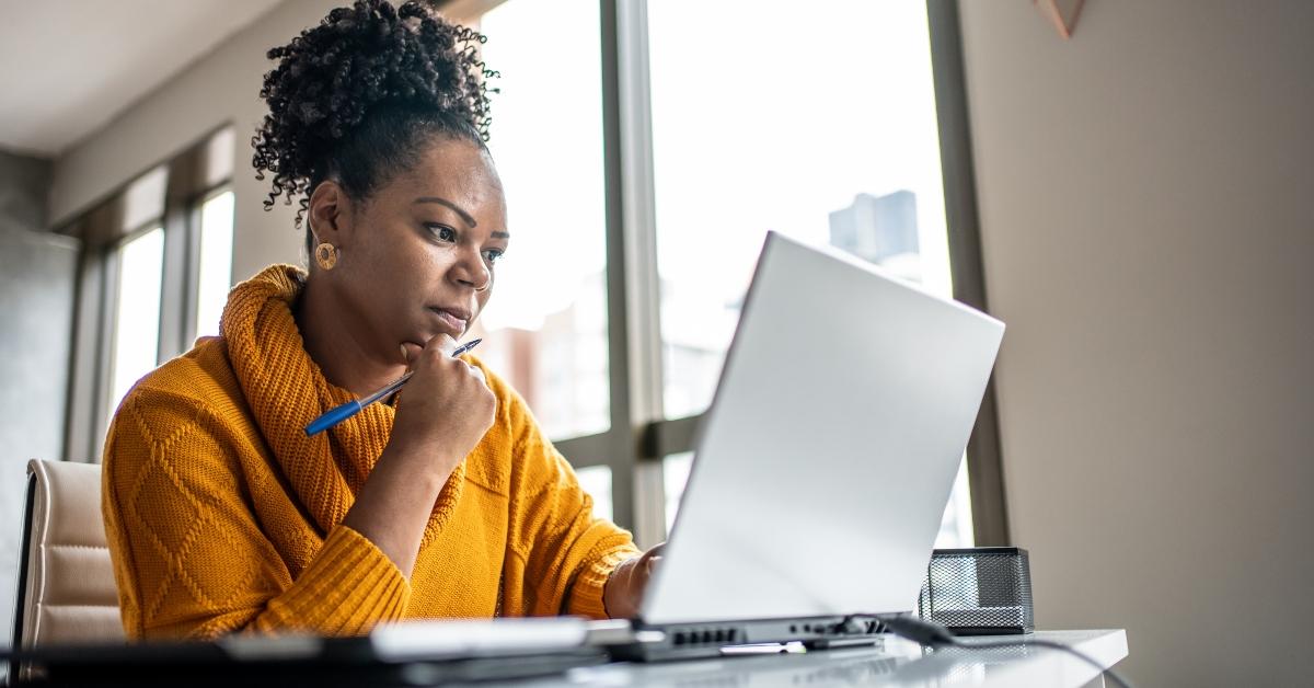 A female credit repair specialist working on a laptop computer