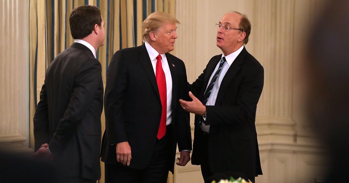 Donald Trump (center) and BlackRock CEO Larry Fink speak at a policy forum.