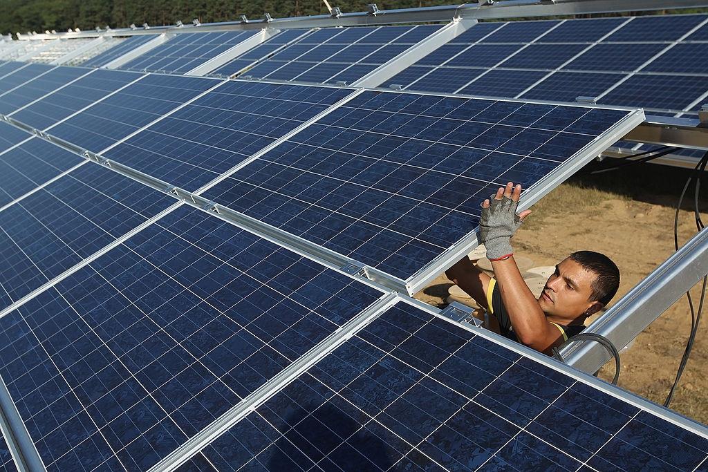 A worker installs solar panels