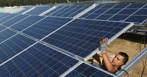 A worker installs solar panels