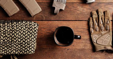 Cup of Black Rrifle coffee with work gloves