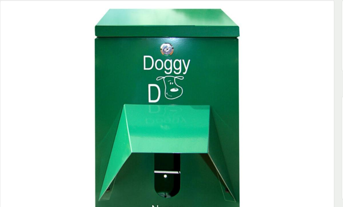 A green dog waste bag dispenser