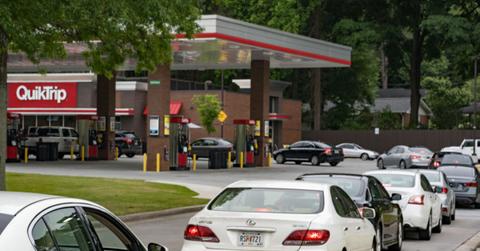Cars lined up at a gas station