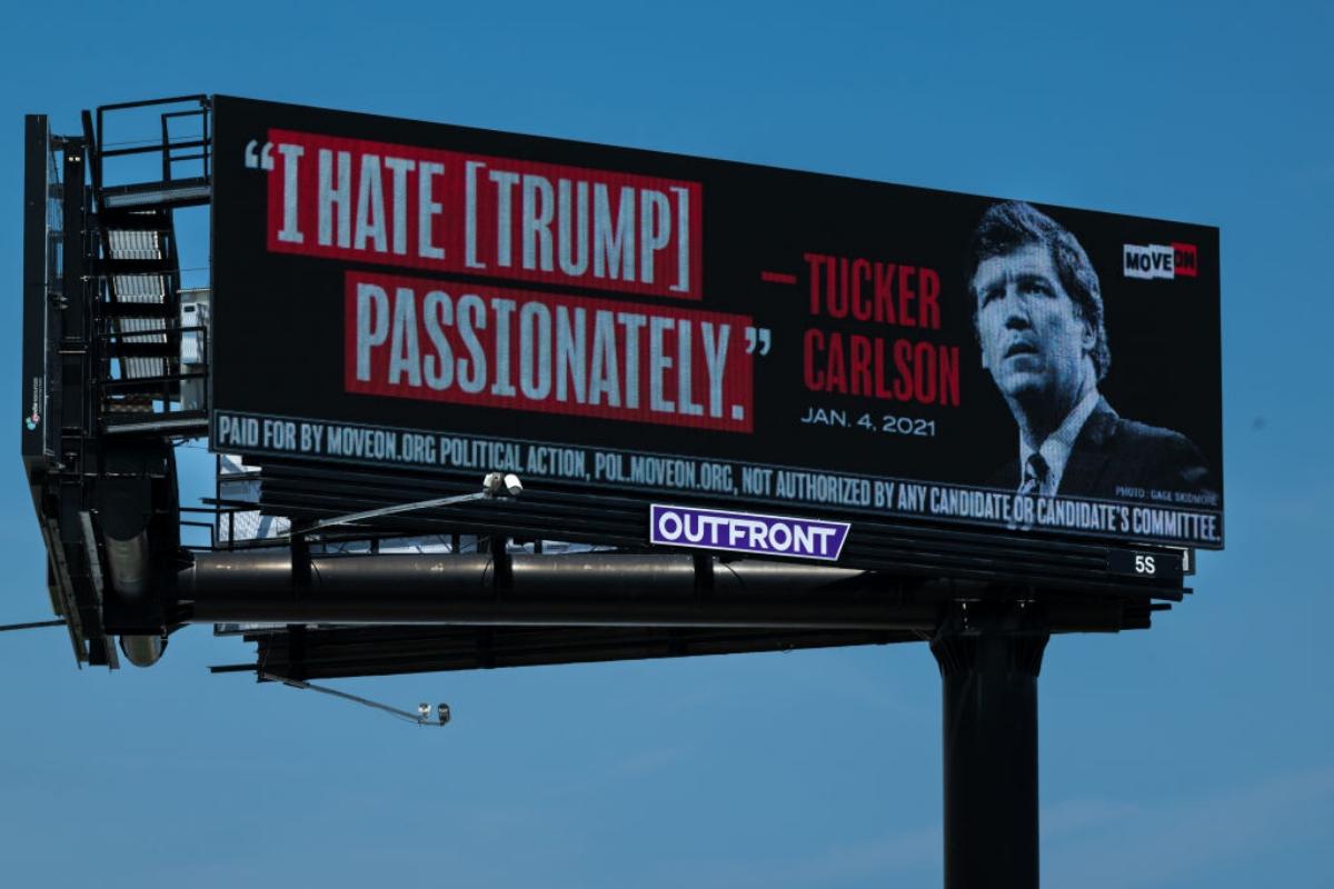 A billboard of a Tucker Carlson quote against Trump