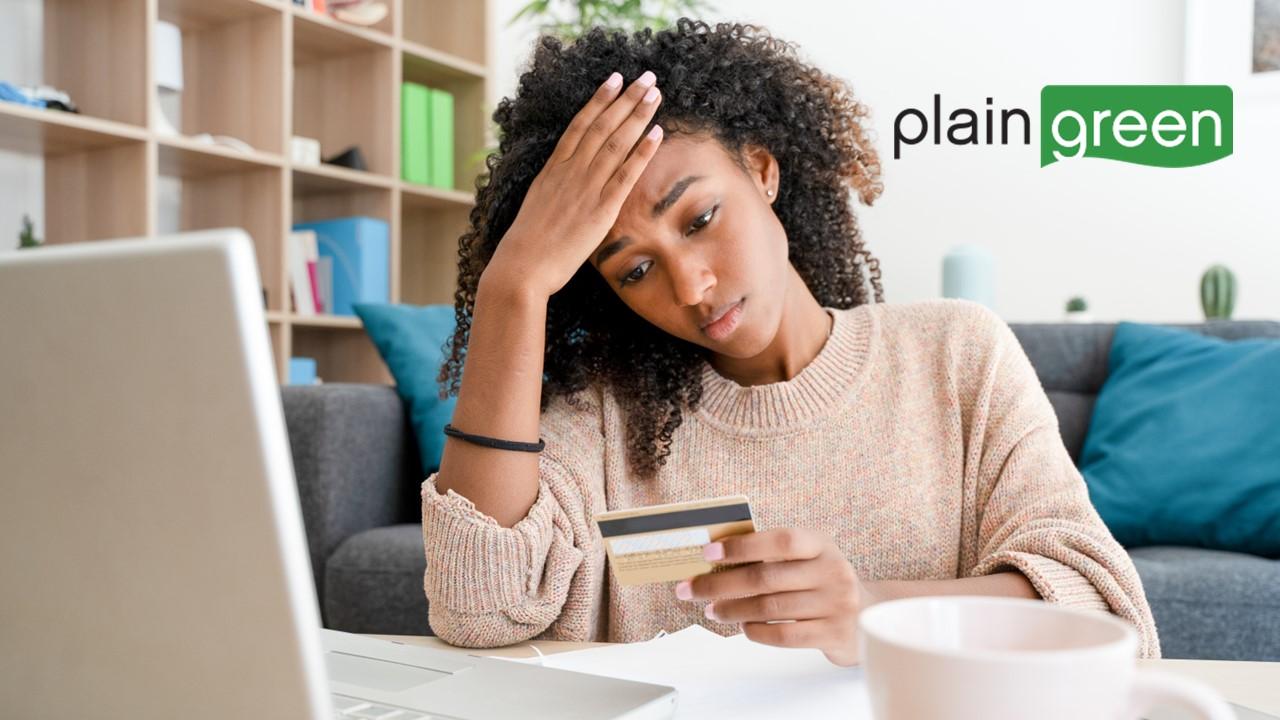 Woman on a laptop and Plain Green logo