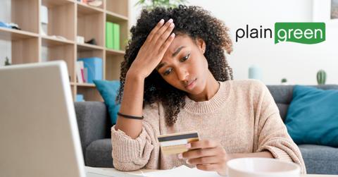 Woman on a laptop and Plain Green logo