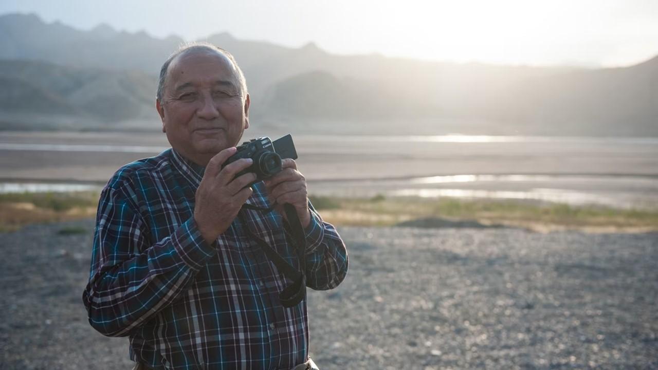 A retired man working as a photographer