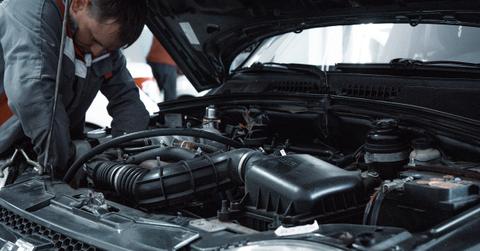 A person repairing a car