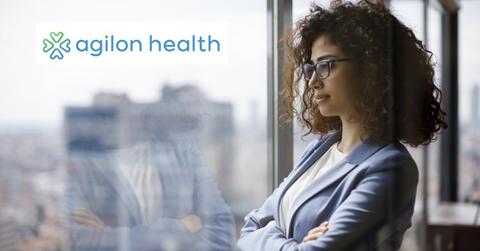 Woman standing at a window and Agilon Health logo