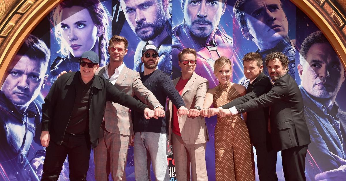 Chris Evans poses with costars at event. 