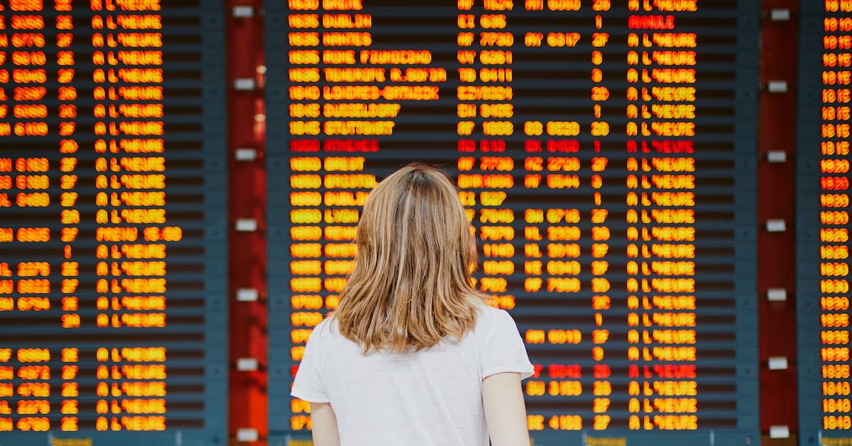 Woman looks at flight board