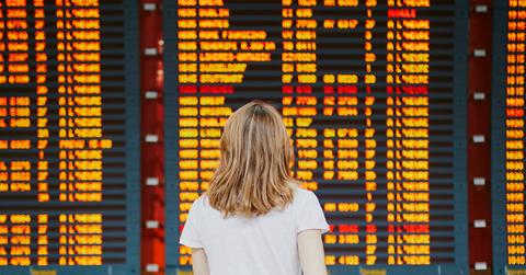 Woman looks at flight board