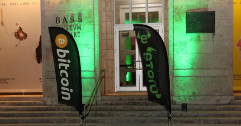 Bitcoin and eToro flags outside of building