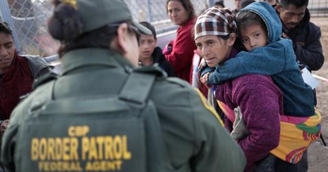 A border patrol agent talking to immigrants
