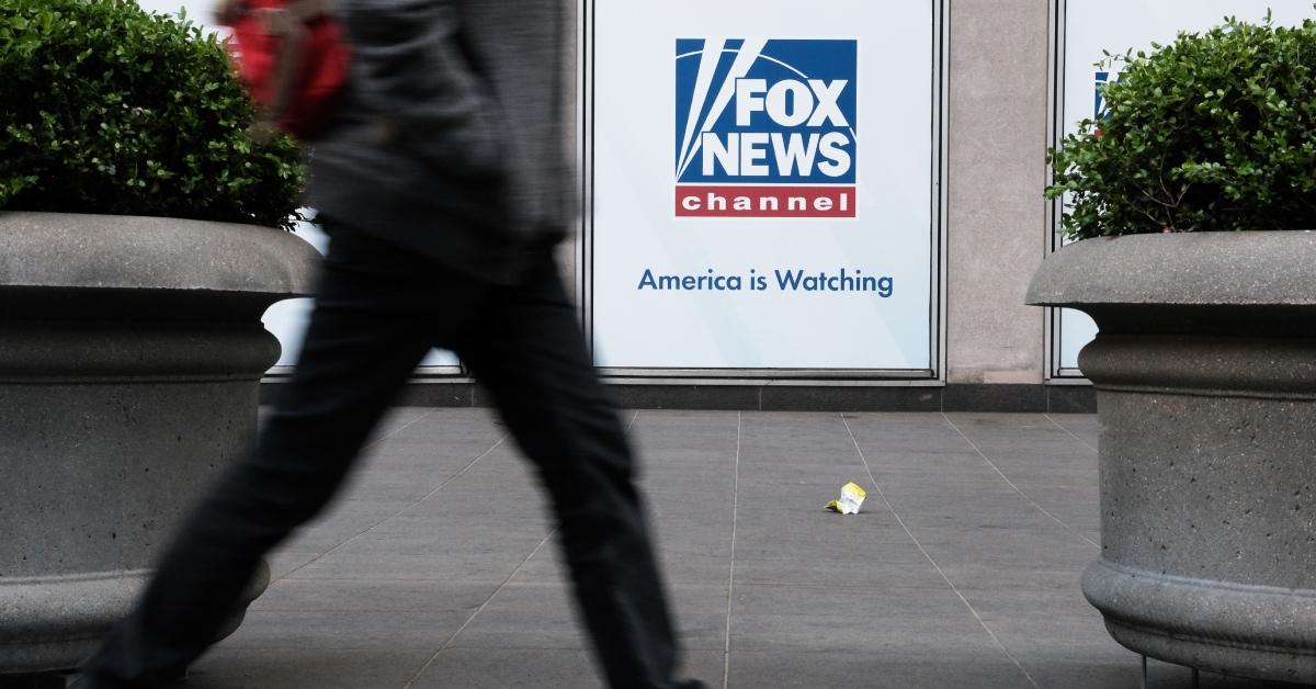 A person walking by the News Corporation headquarters, home to Fox News.